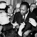 Martin Luther King, Jr. and Lyndon Johnson as the Civil Rights Act is signed